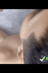 Two Young Muscular Men in an Intimate Bedroom Scene