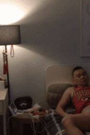 Two Young Muscular Men in an Intimate Bedroom Scene