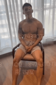 A Young Muscular Man in an Intimate Bedroom Scene